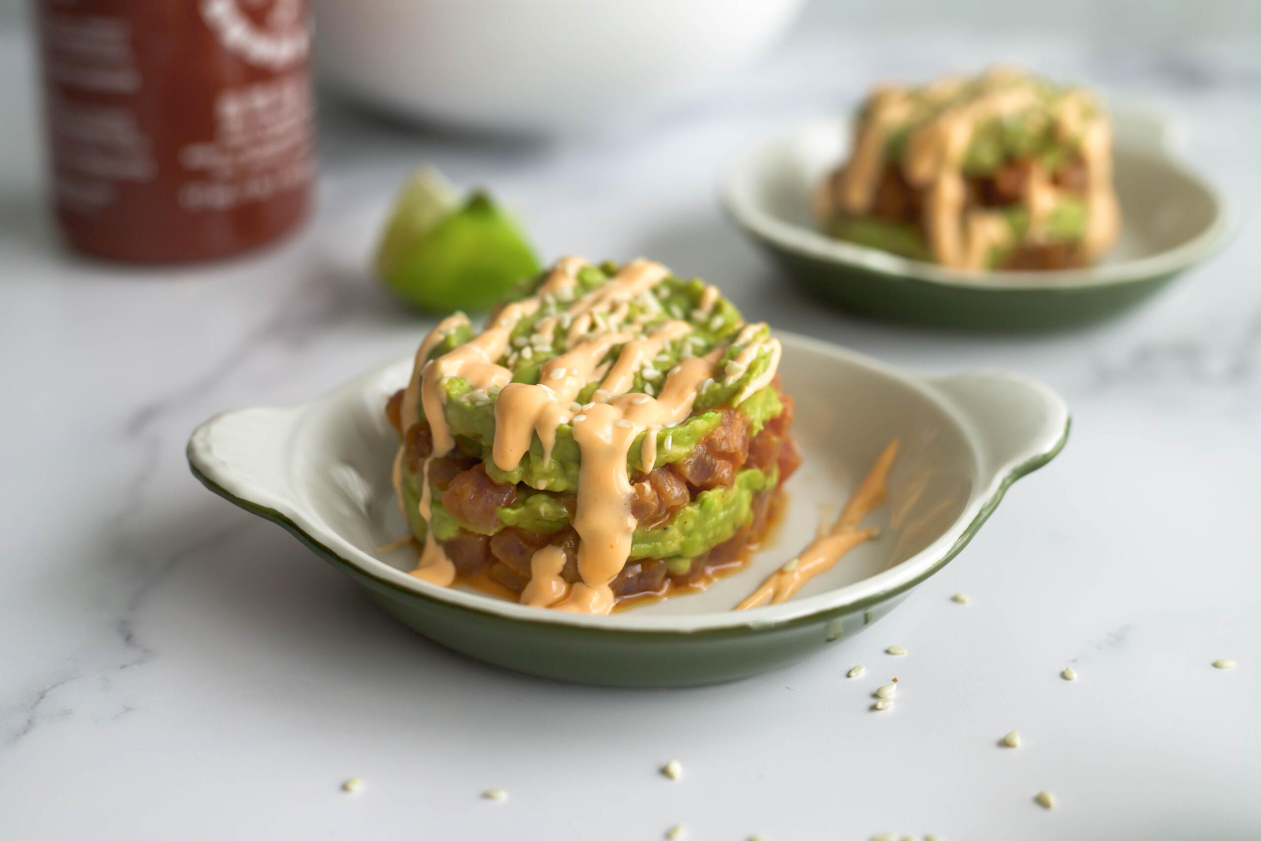 spicy tuna and avocado salad served on a plate with crackers