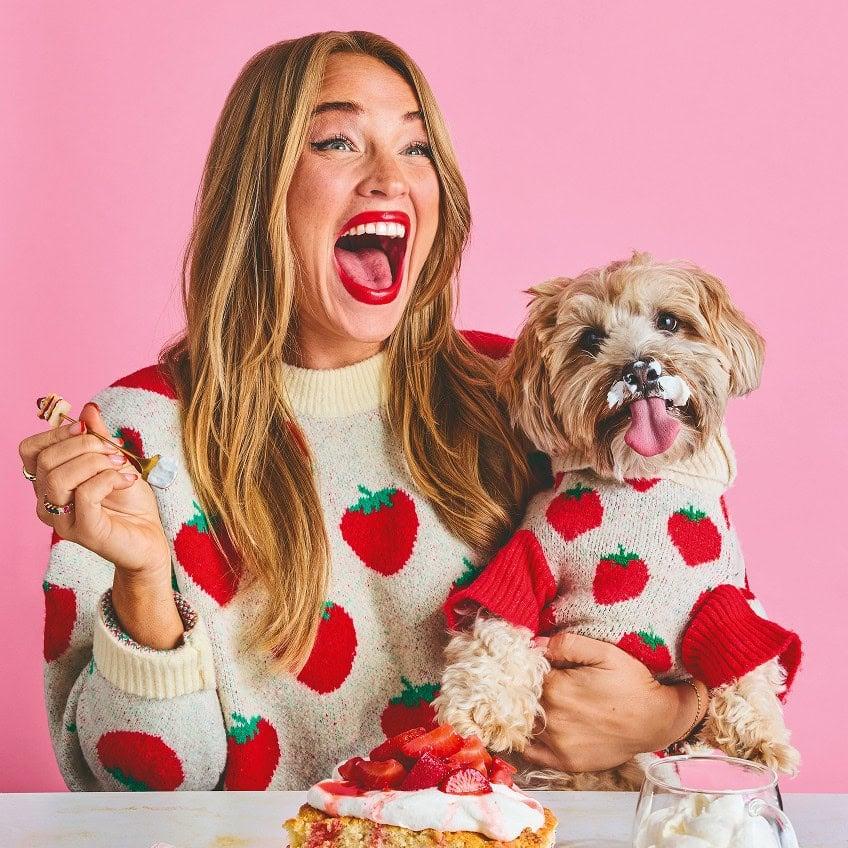 a person smiling and holding a freshly made yuzu mug cake