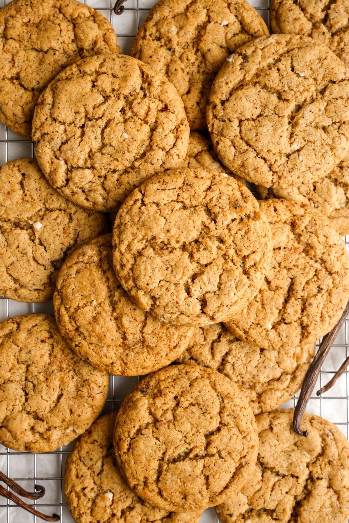 Close-up of freshly baked vanilla bean cookies with a tender crumb texture, on a rustic wooden board