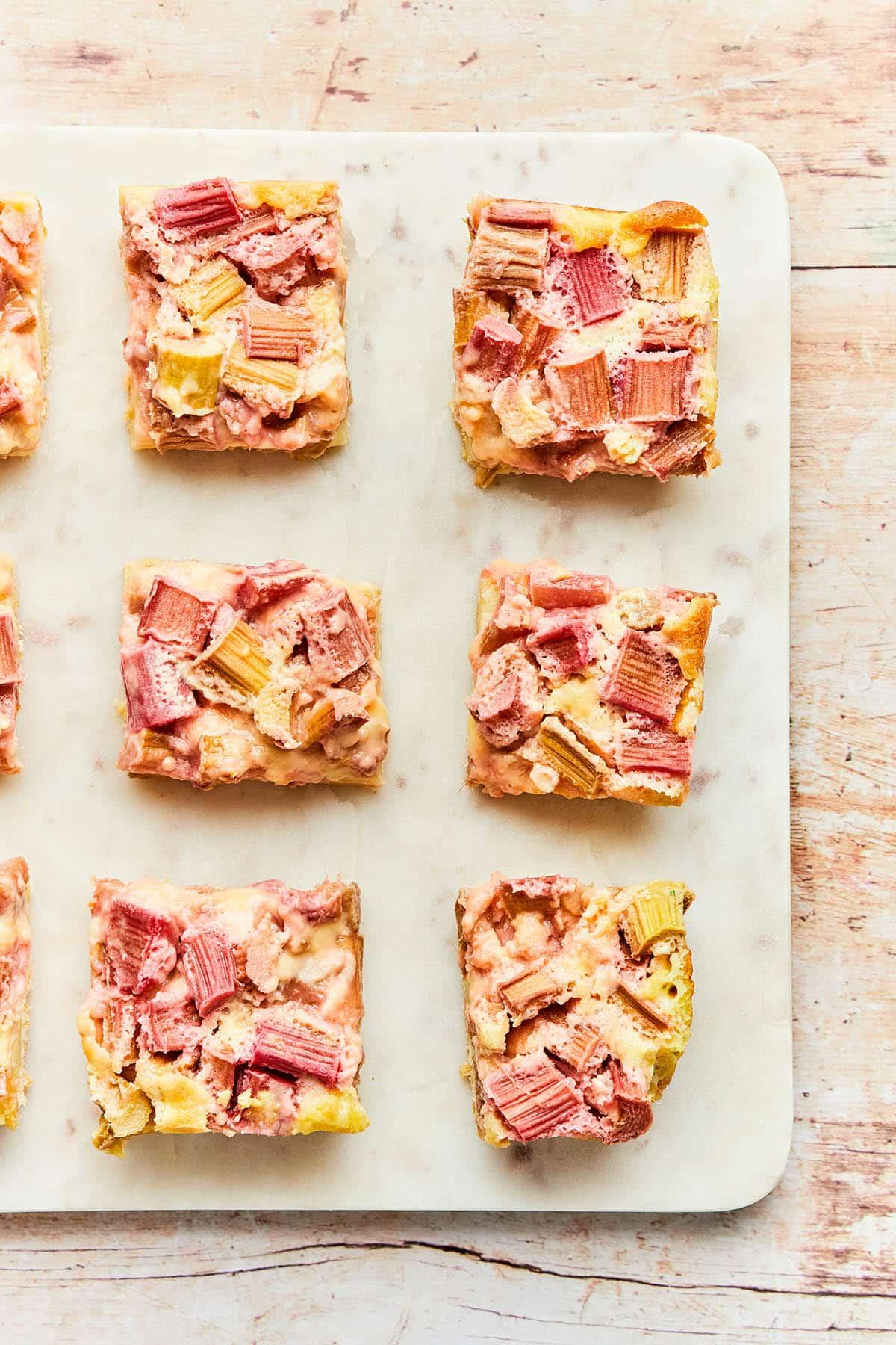 Overhead shot of several Champagne Rhubarb Custard Bars arranged on a platter