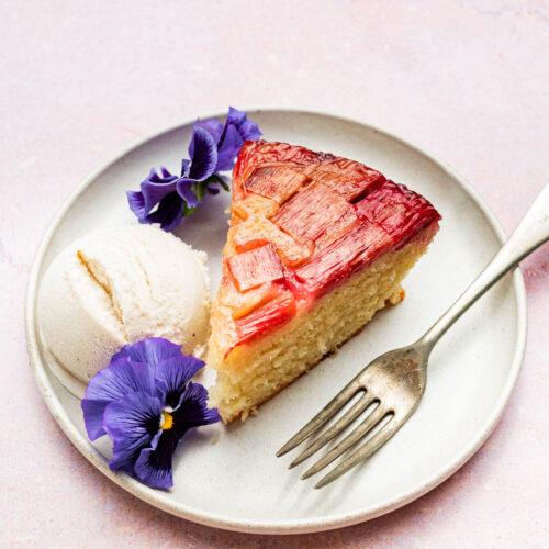 slice of rhubarb cake on a plate with a fork