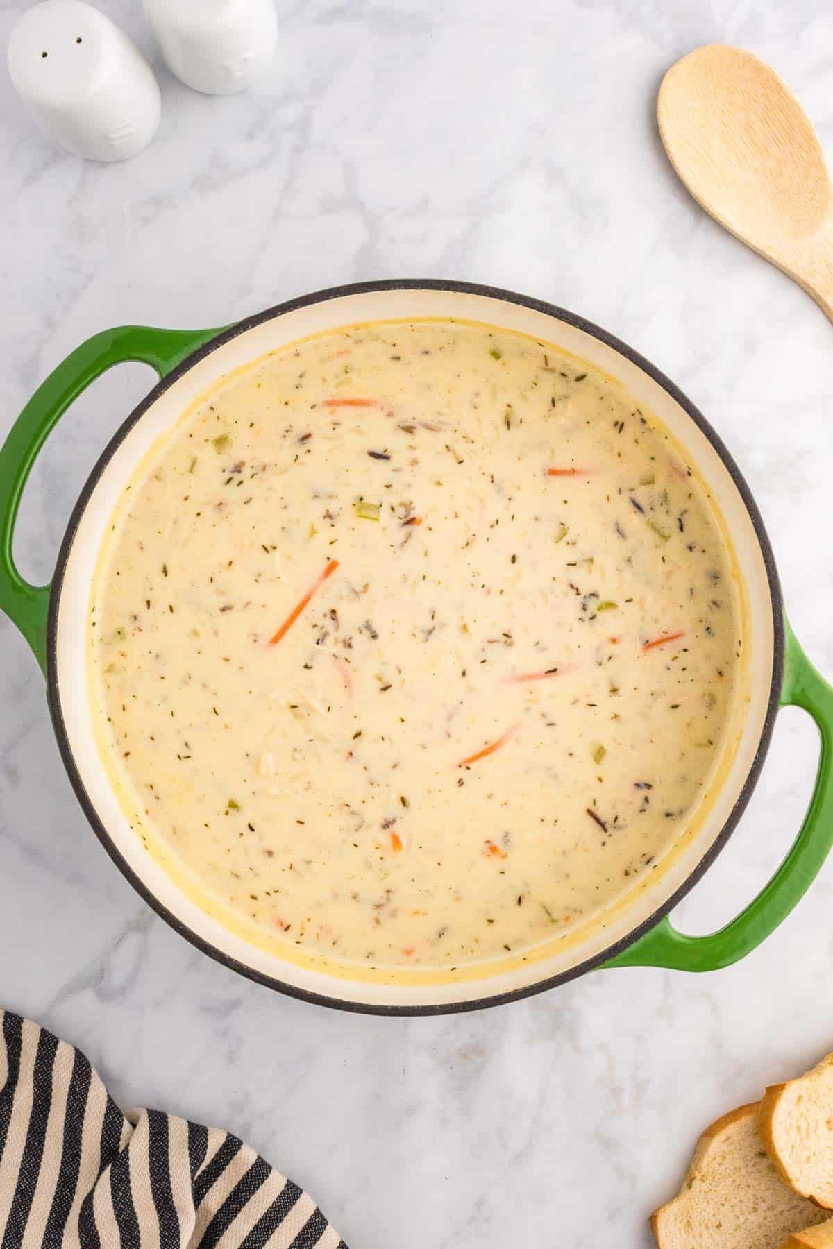 ingredients for chicken and wild rice soup on a wooden countertop