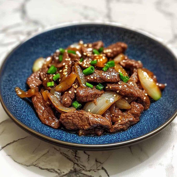 beef stir-fry with dijon mustard and caramelized onions served on a plate