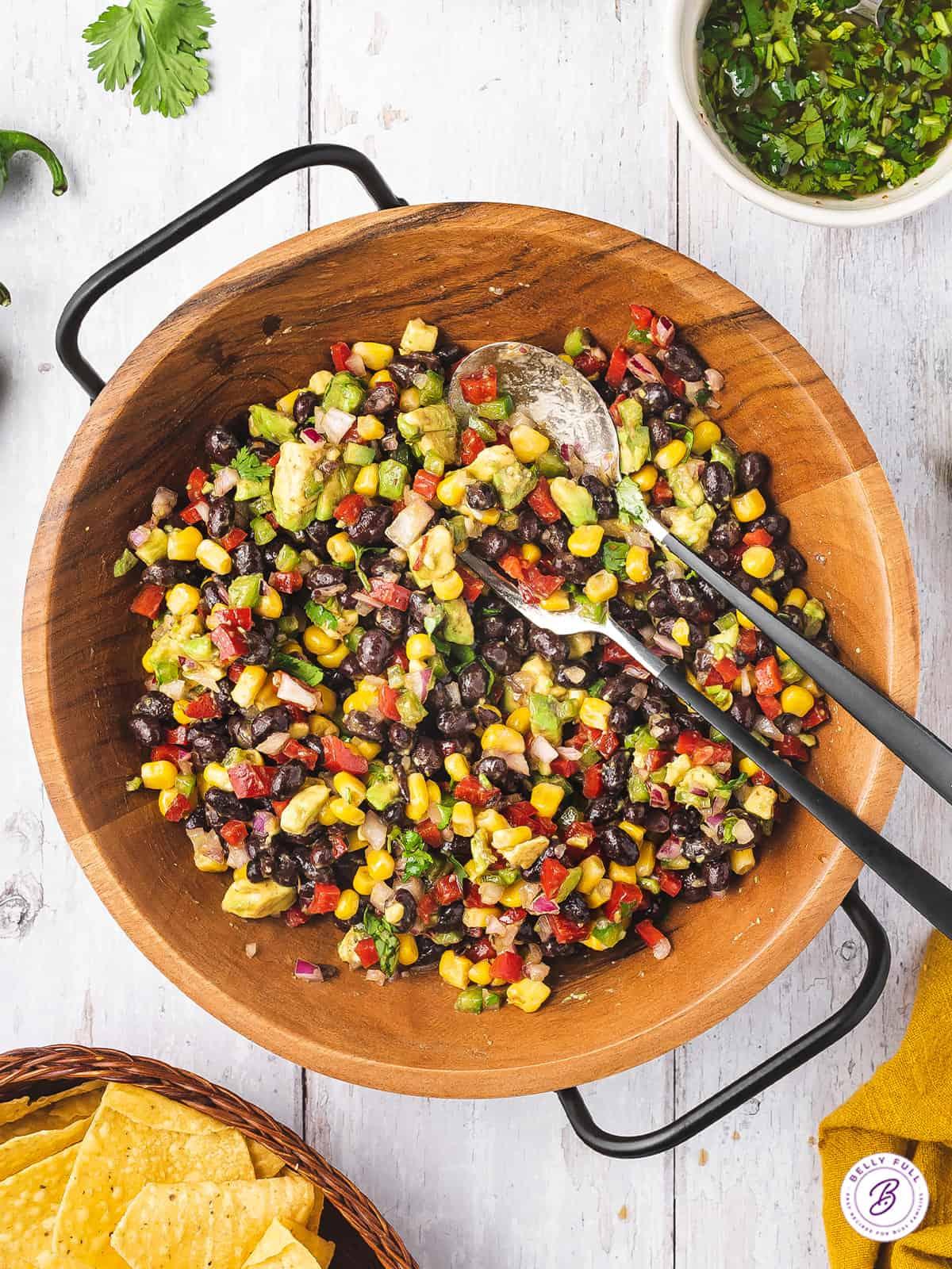 Overhead shot of black bean and corn salsa ingredients laid out on a wooden table