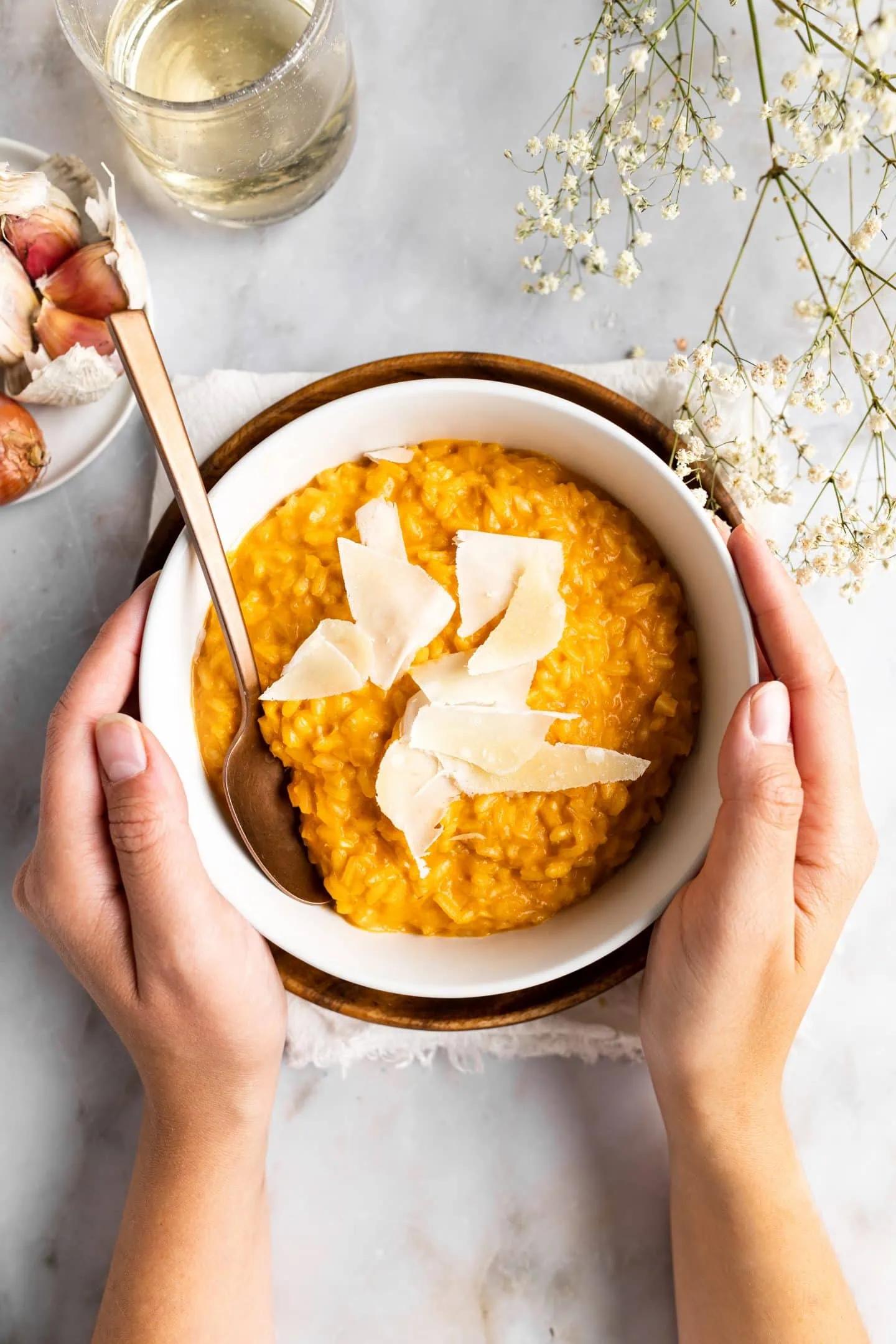 close-up shot of creamy tomato risotto being stirred in a pot, showcasing the creamy texture