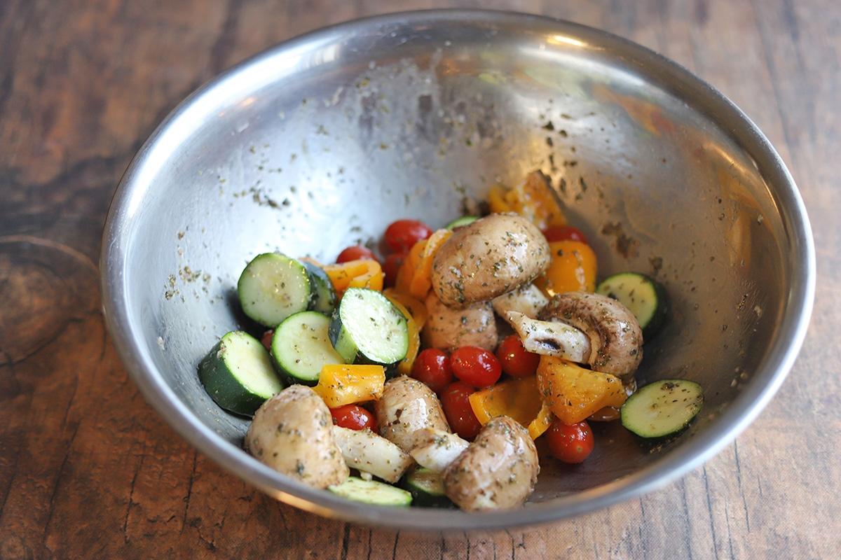 veggie skewers marinating in a bowl