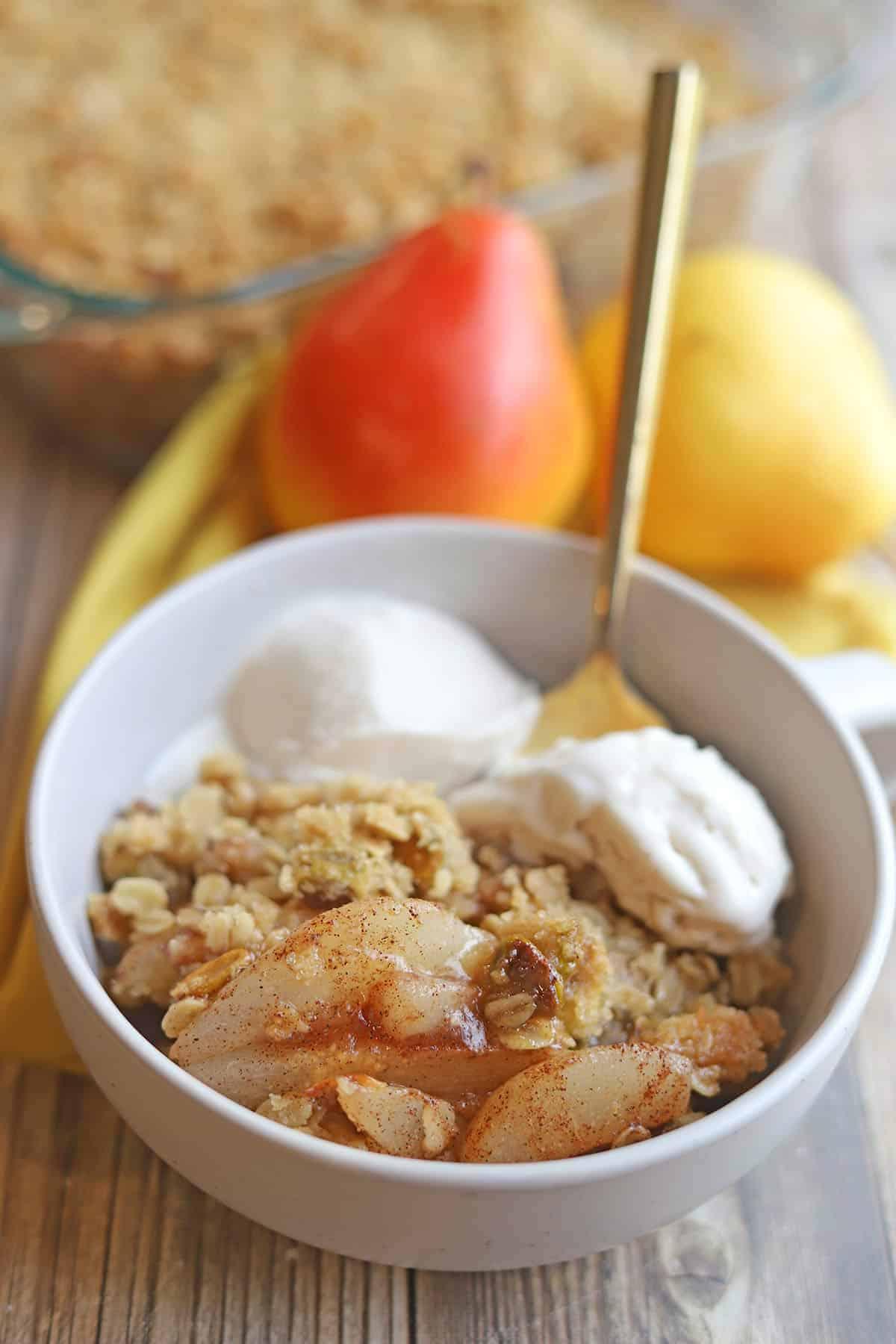 warm pear crisp with creamy custard in a rustic setting