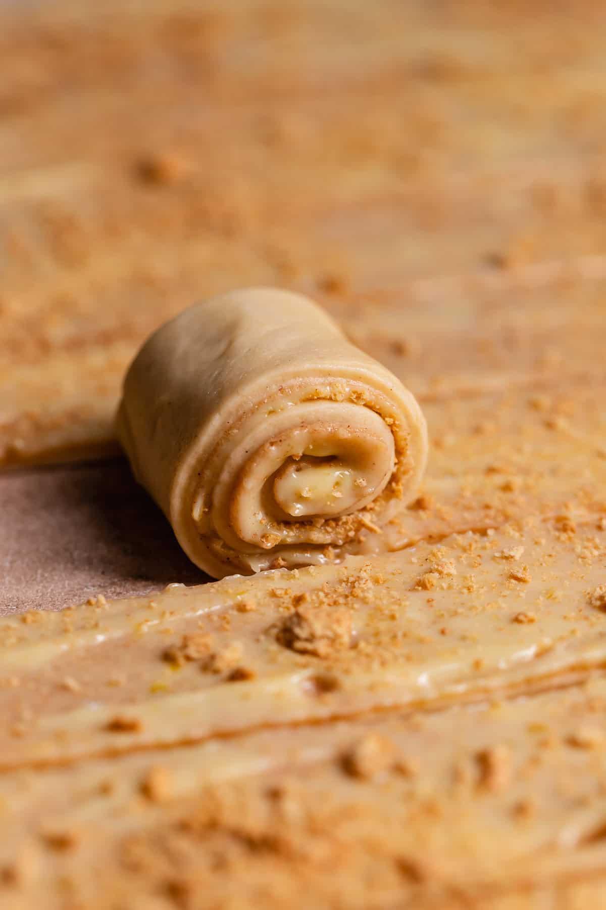 Ingredients for key lime pie spring rolls laid out on a wooden surface