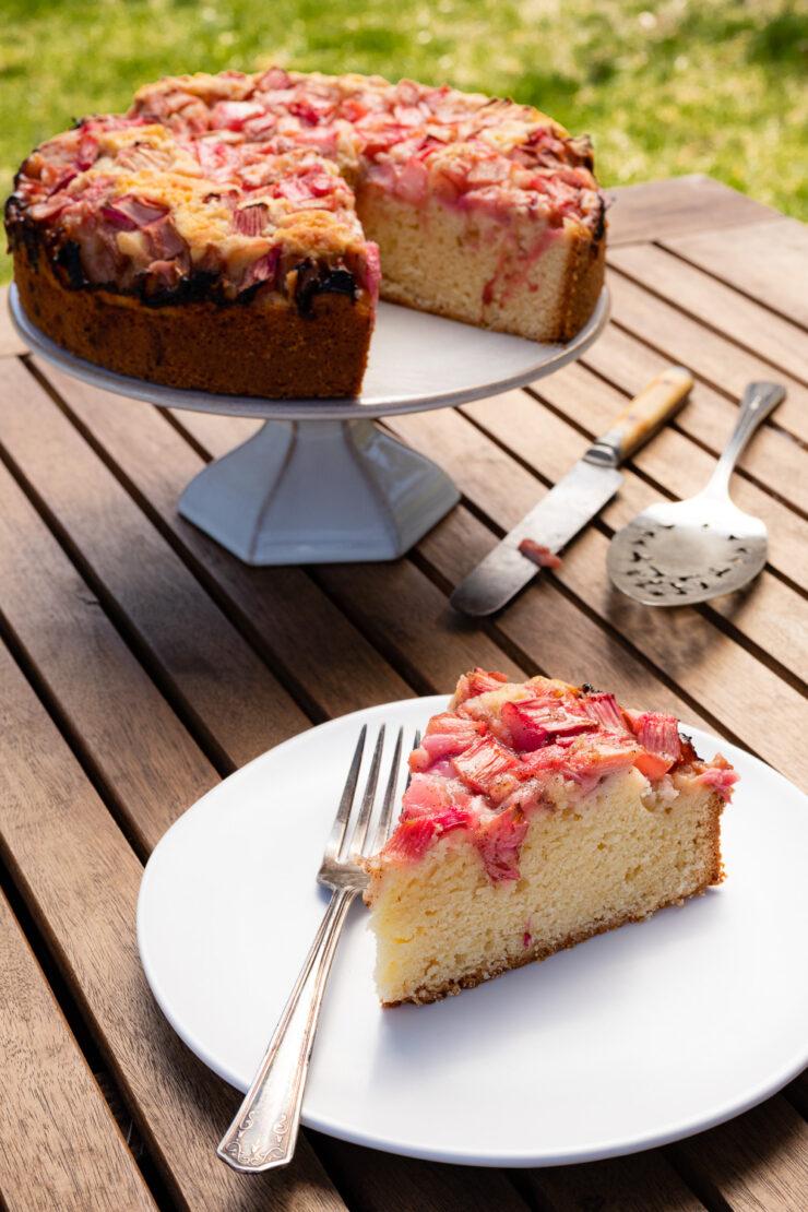 Rhubarb Cheesecake Cake on a wooden table, rustic setting