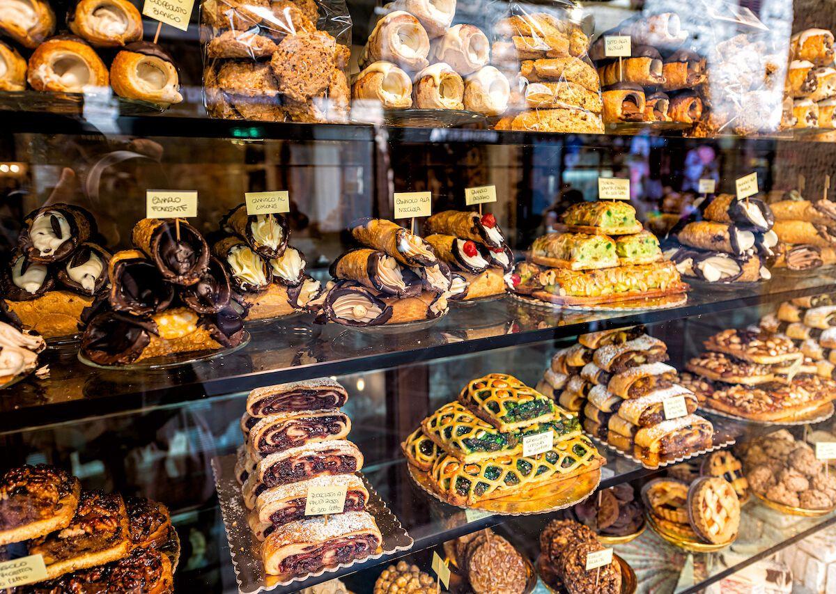 A charming Italian bakery with a variety of pastries and cakes displayed