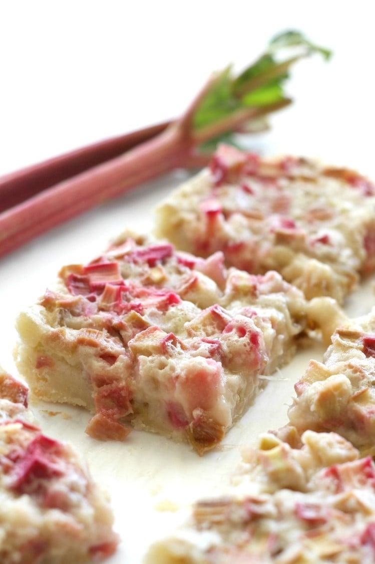 close up of sweet and spicy rhubarb custard bar with a slice cut out