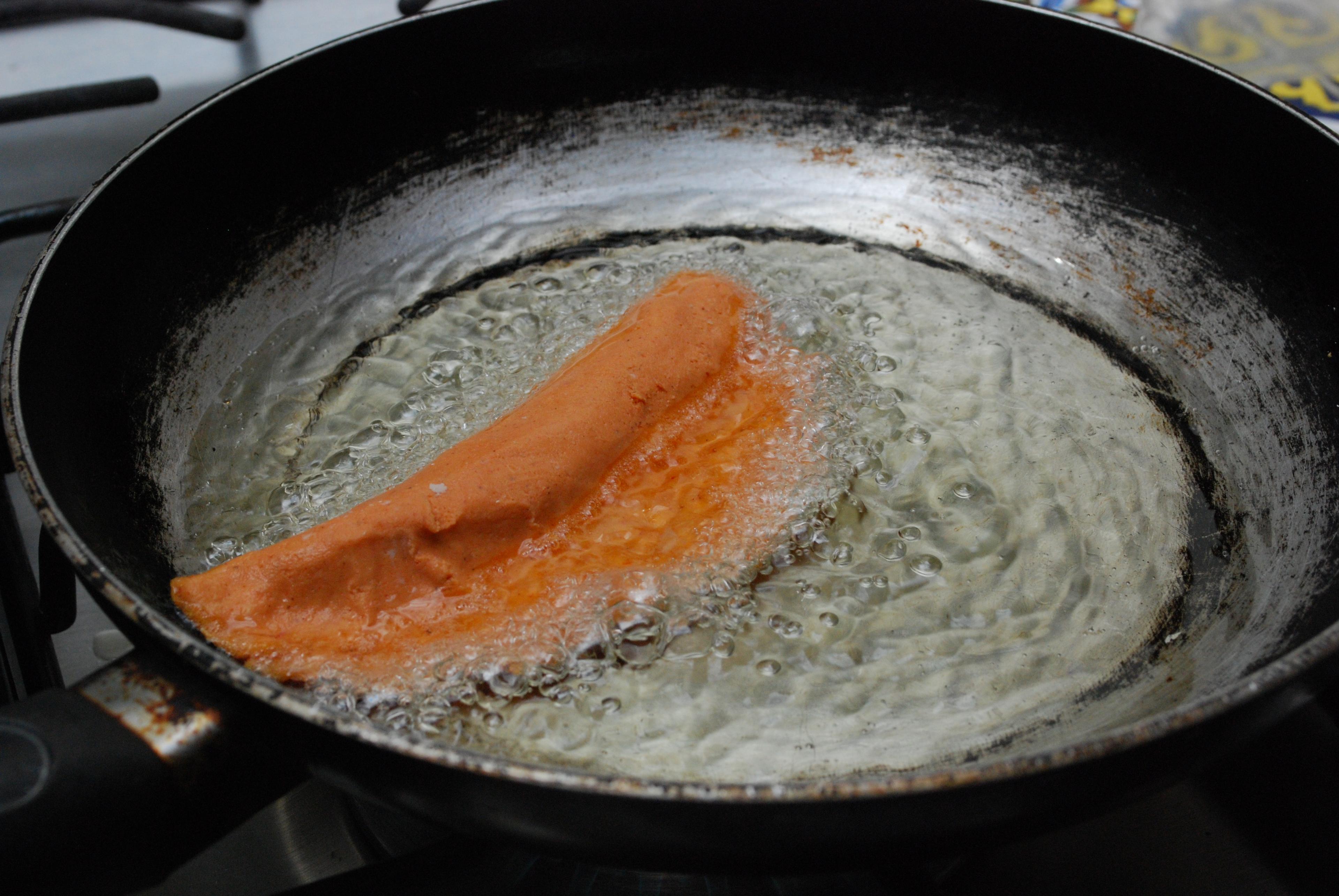Molotes quesadillas being fried in a pan