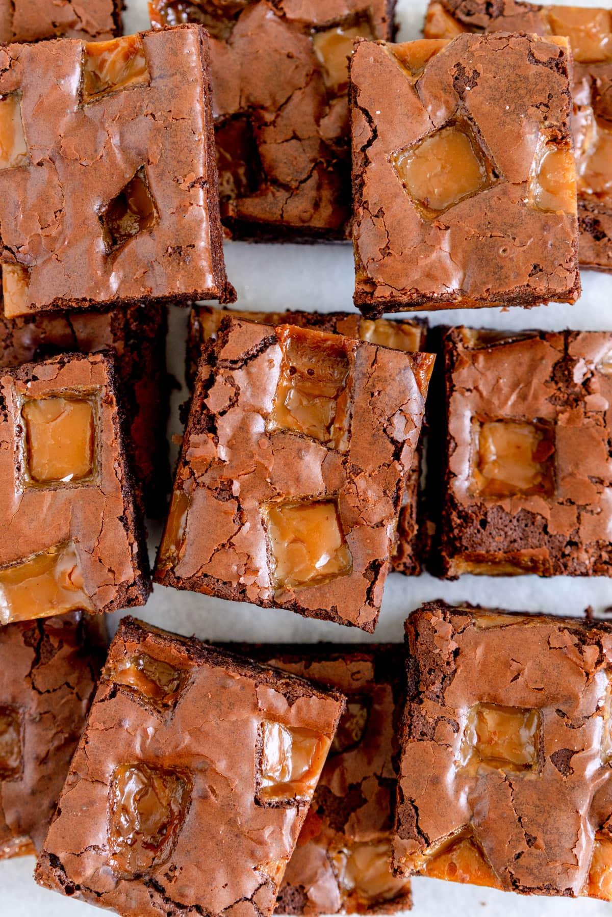 chocolate caramel brownies being cut into squares
