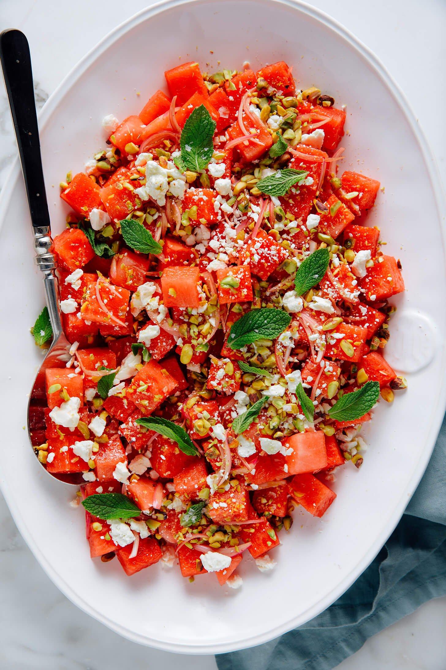 a bowl of watermelon tabbouleh salad with fresh mint garnish