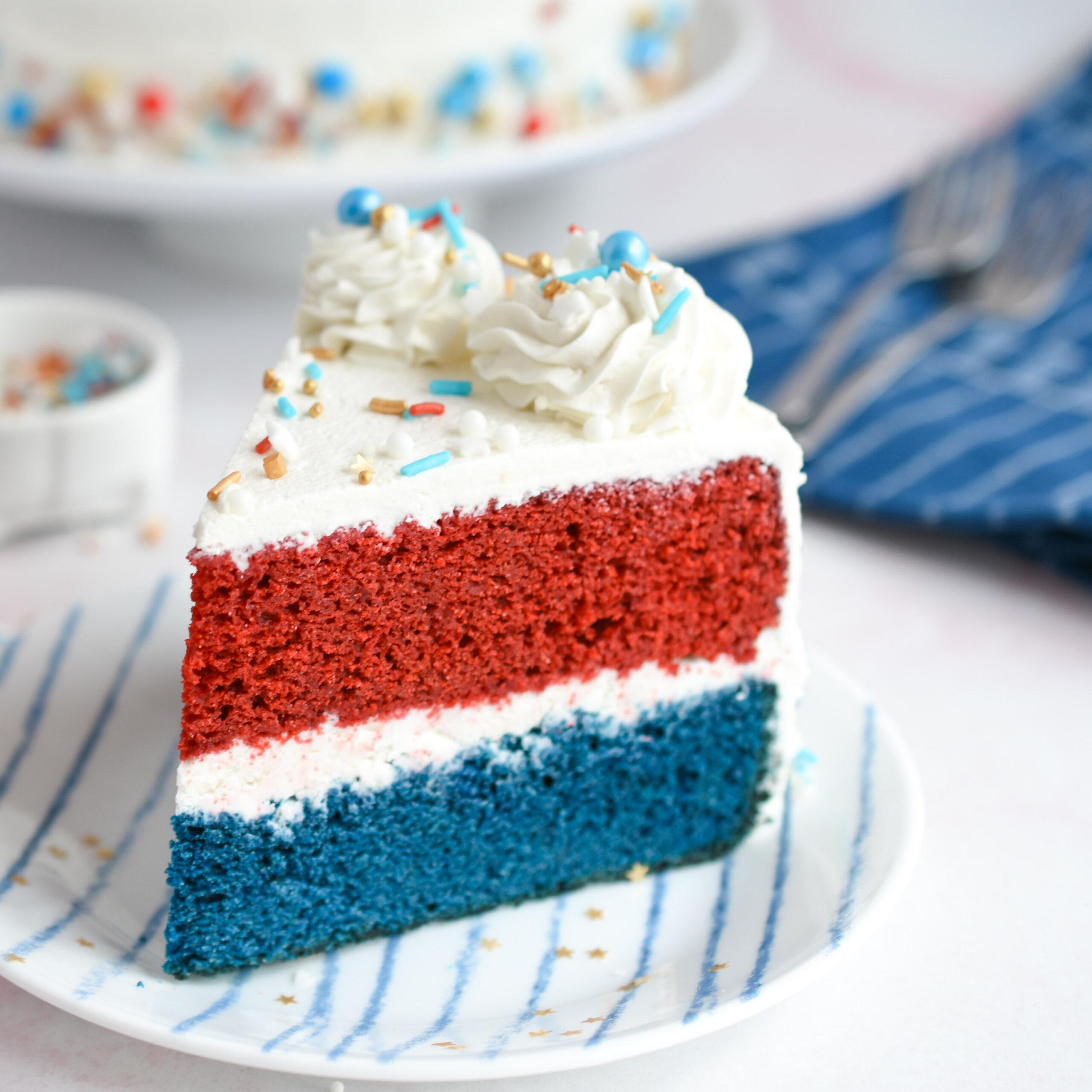 red white and blue velvet cake being frosted with cream cheese frosting
