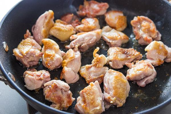 Overhead shot of sriracha chicken being prepared in a pan