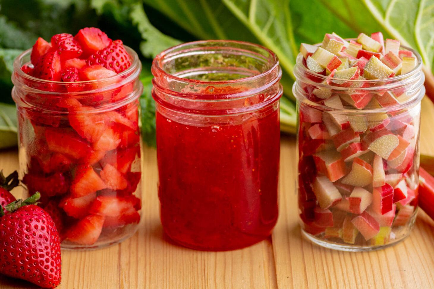 selection of jars of homemade rhubarb conserve on a wooden shelf