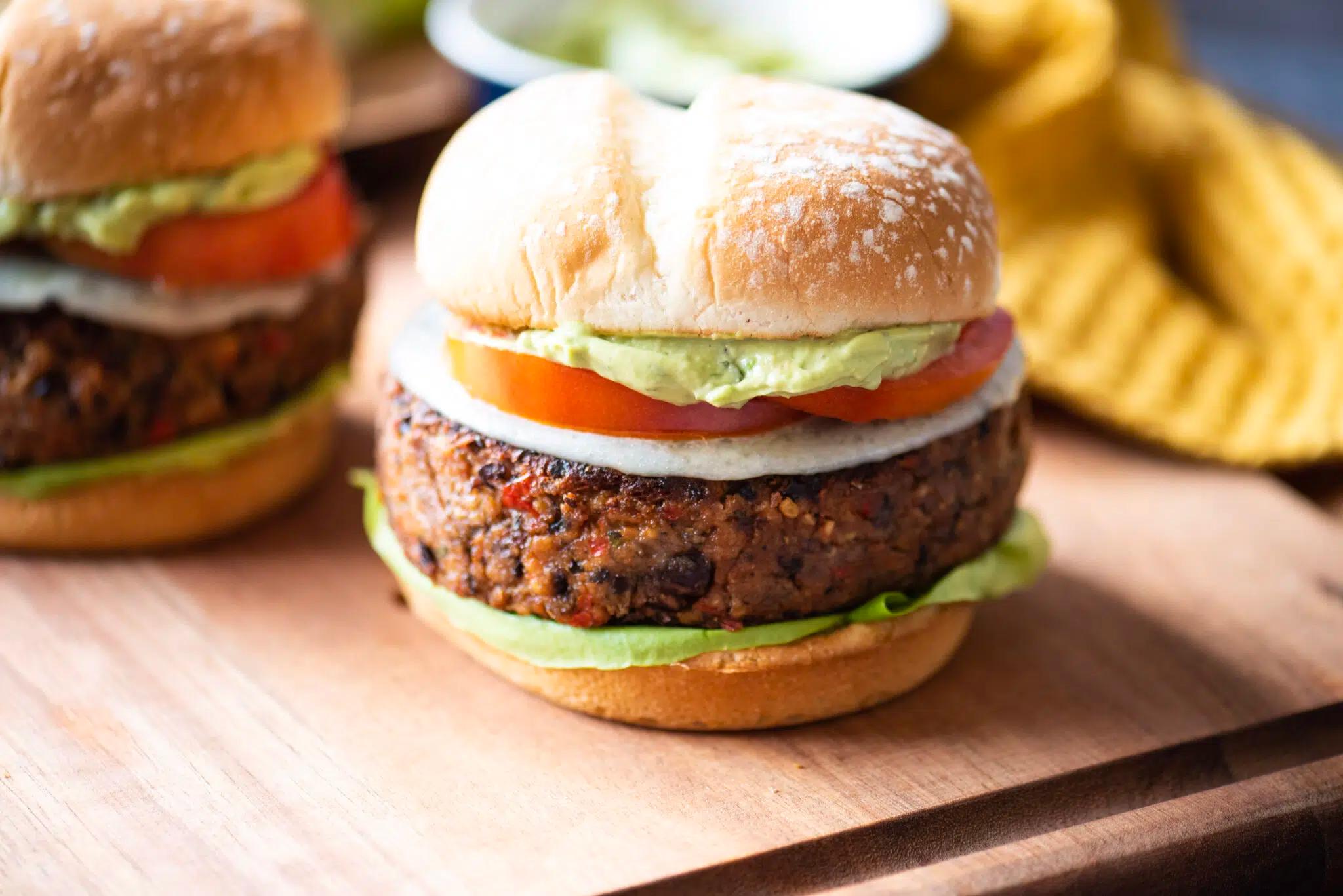 spicy black bean burger on a bun with avocado and toppings