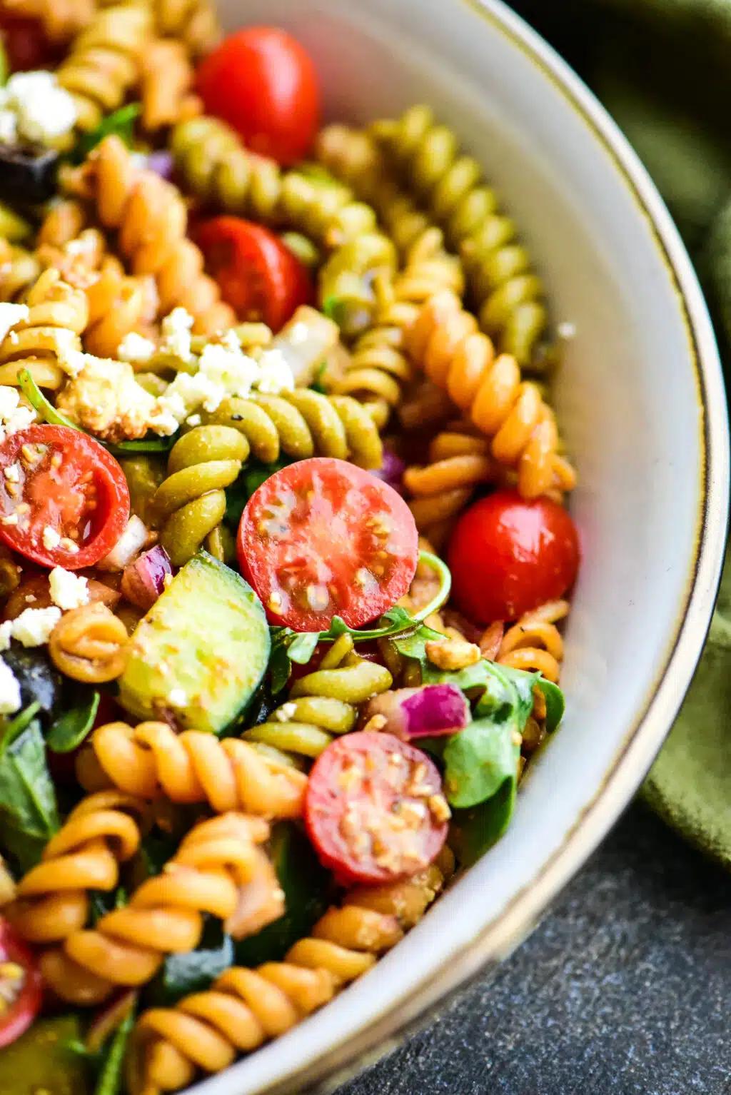 Close-up shot of Greek Pasta Salad with cranberries and thyme