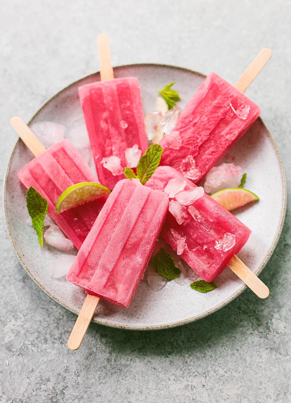 homemade hibiscus lime popsicles on a wooden board