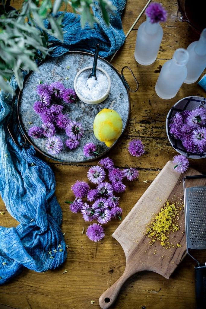 rustic kitchen scene with rhubarb stalks and violet flowers