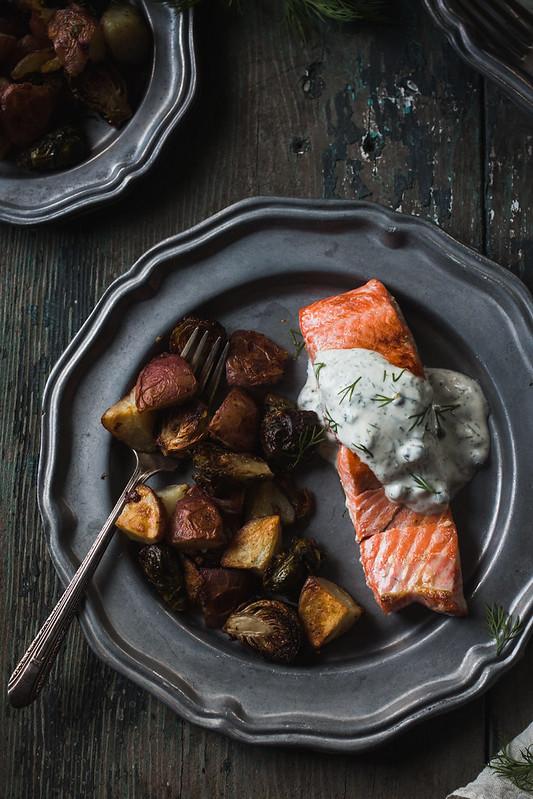 close up shot of roasted brussels sprouts with smoked salmon and dill on a plate