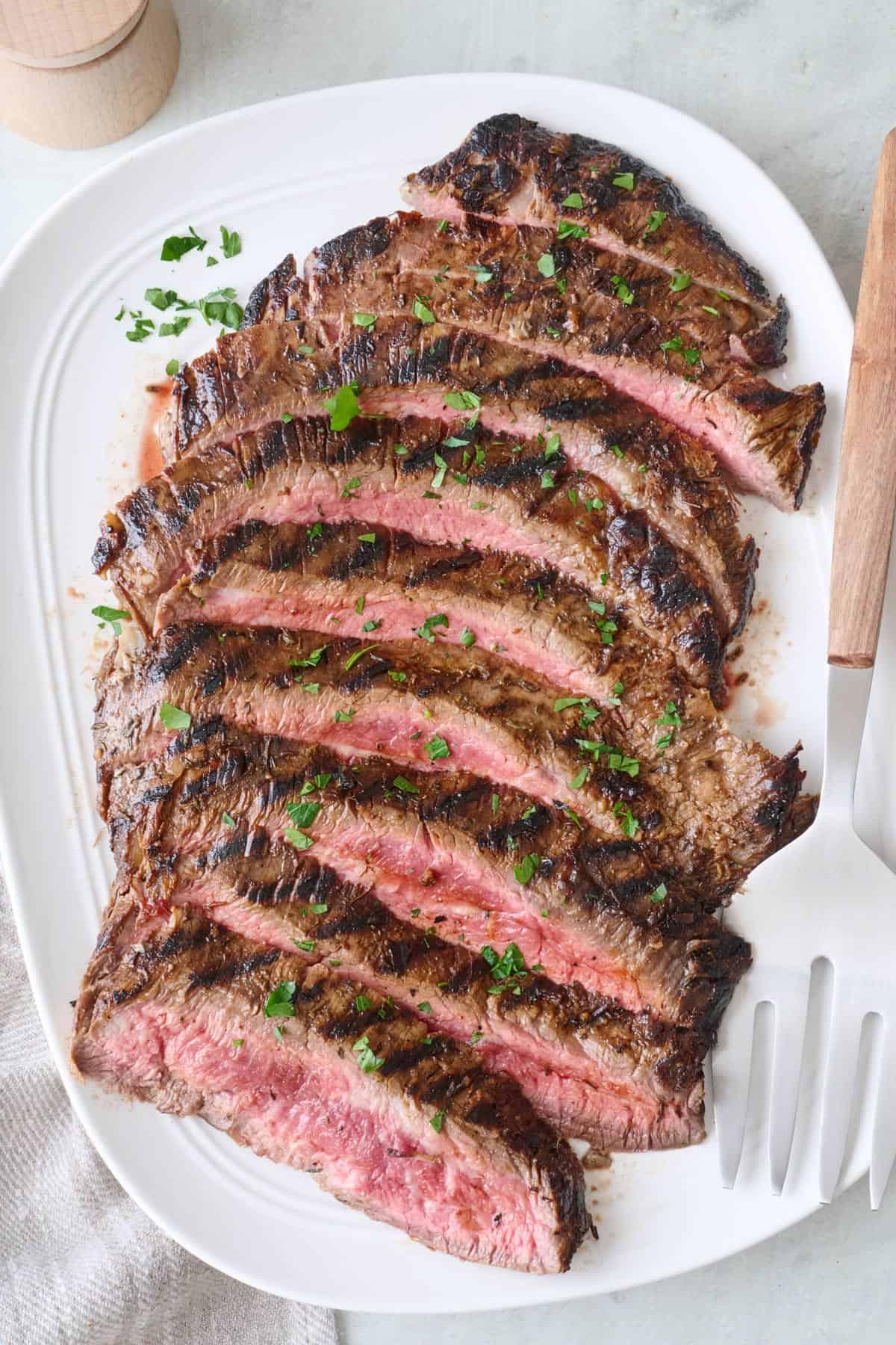 grilled flank steak being sliced