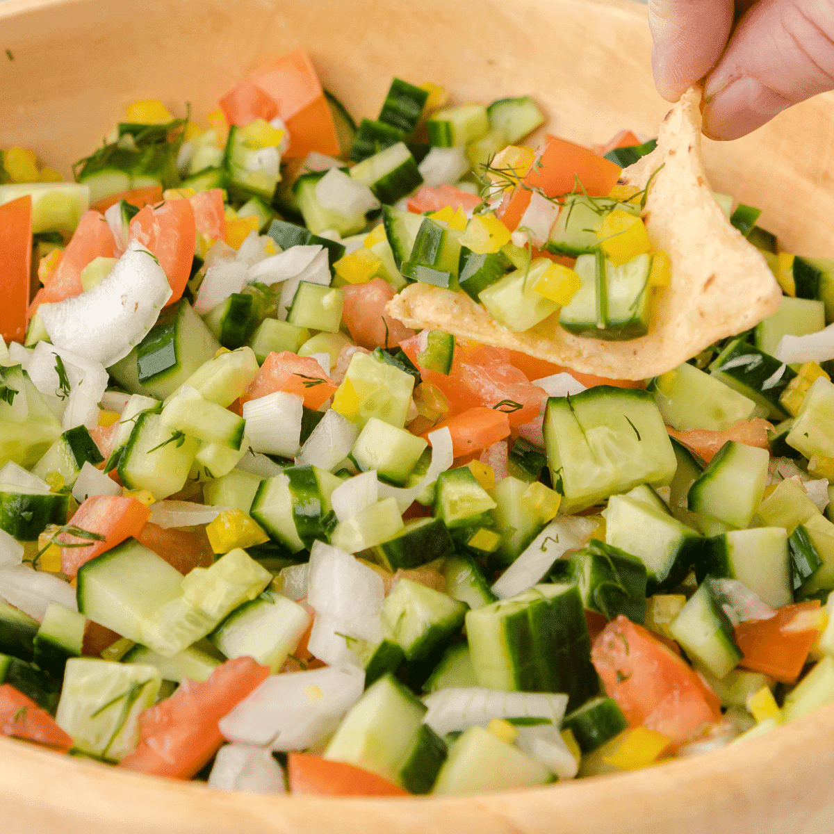ingredients for cucumber kiwi salsa salad arranged on a wooden cutting board