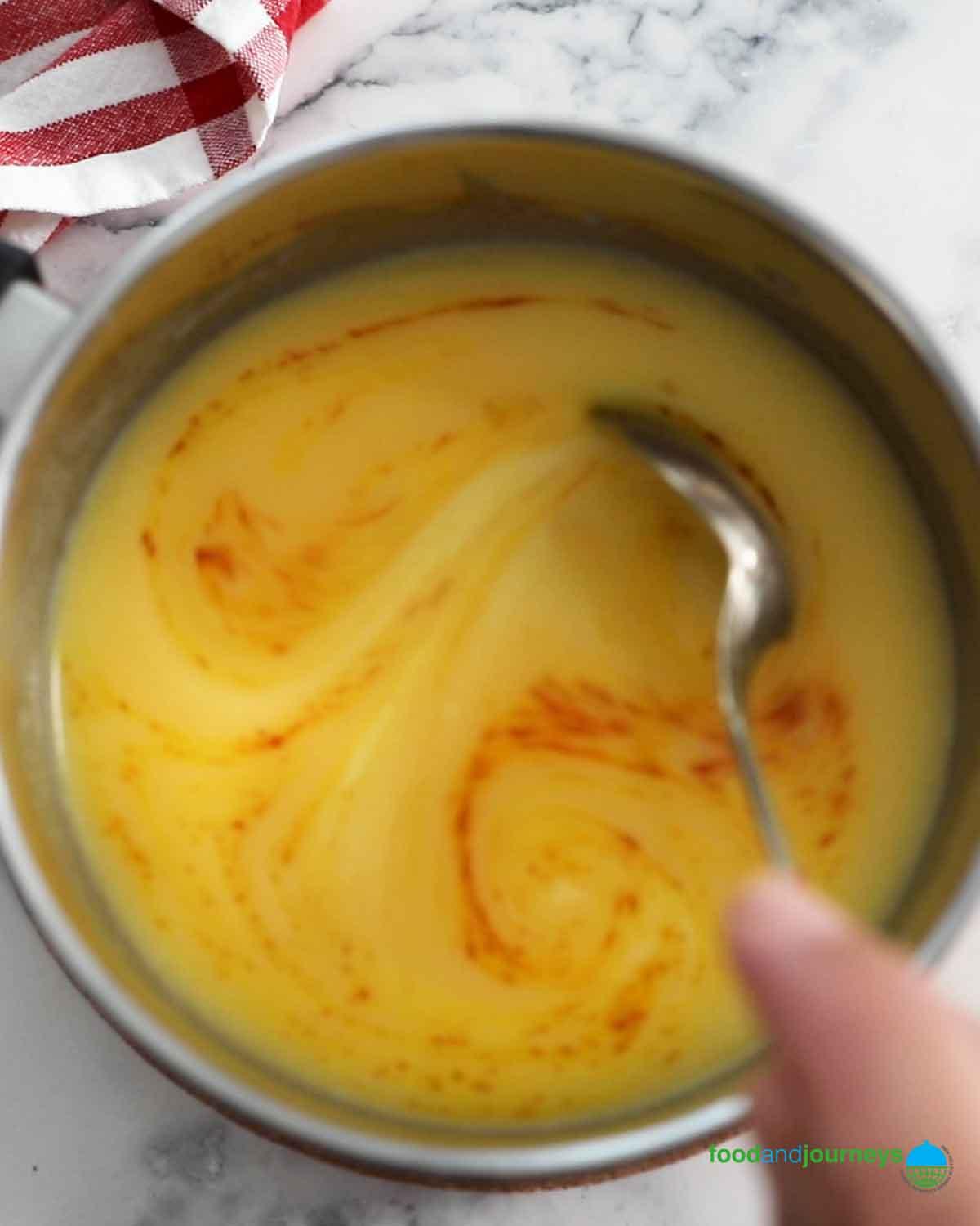 close-up shot of saffron threads being added to a bowl of cake batter