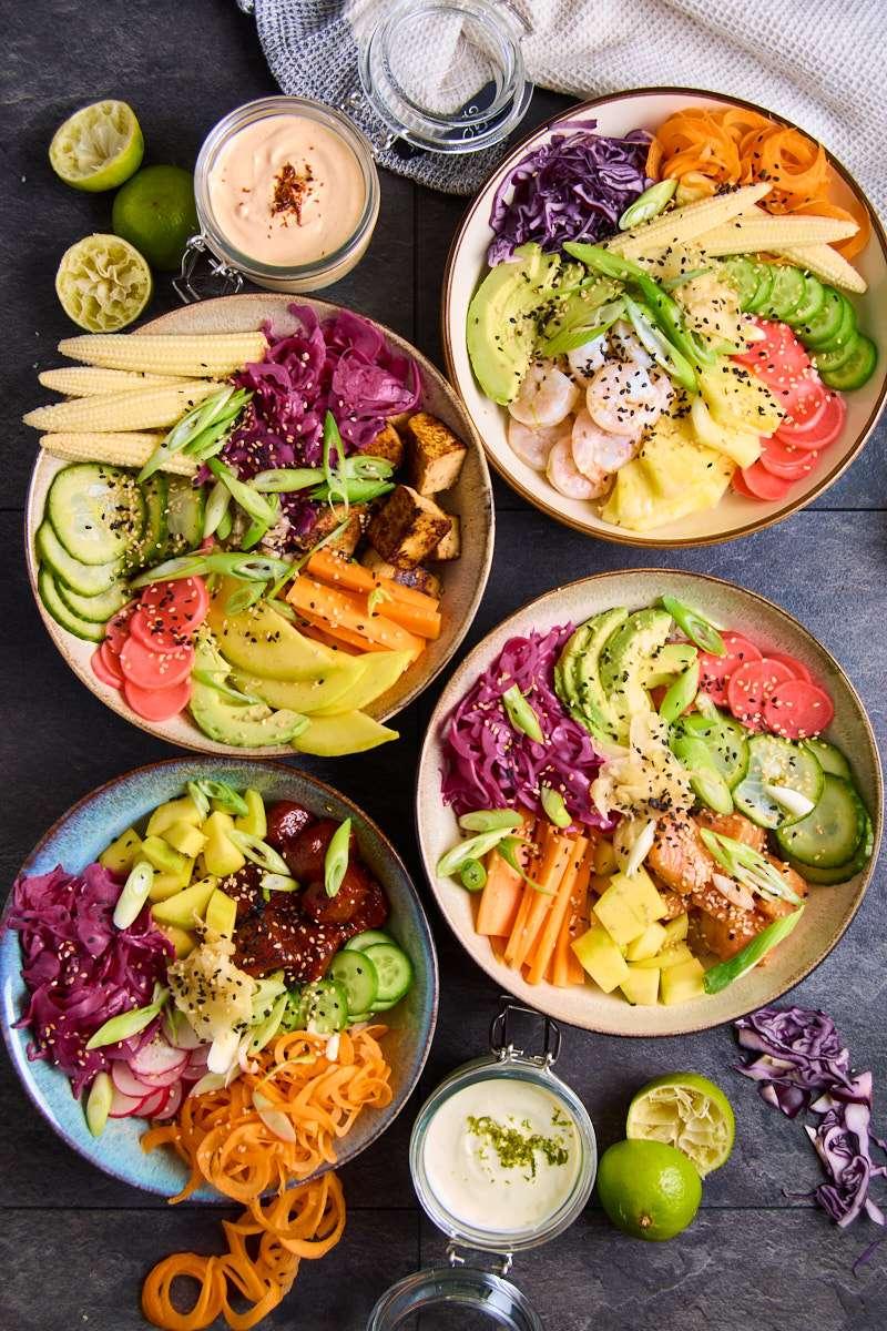a variety of sushi bowl toppings arranged in small bowls