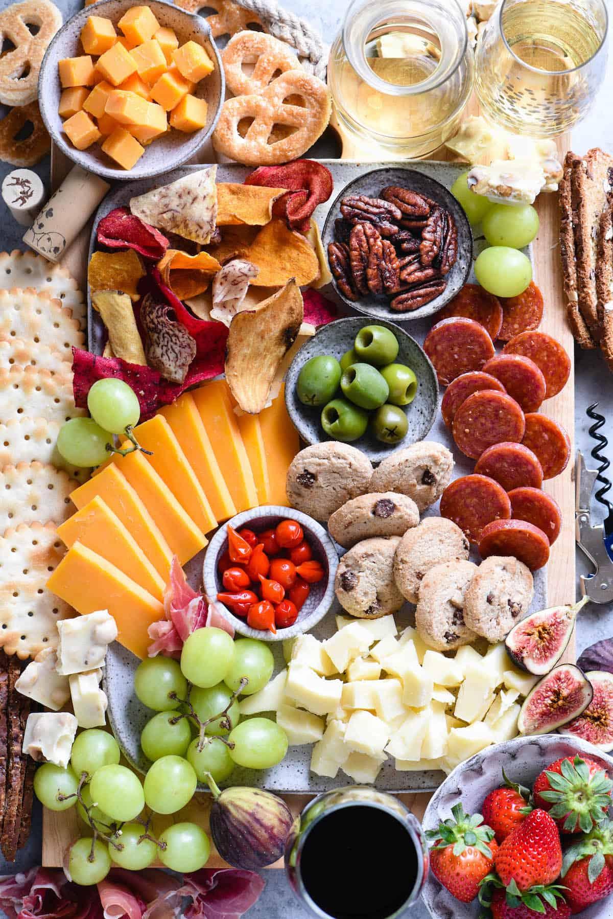 A cheese flight board with different types of cheese and crackers