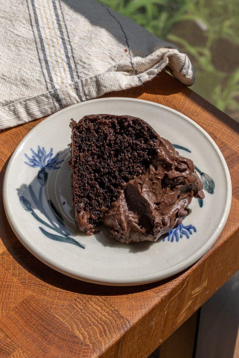 close up view of a slice of balanced cake being lifted off a plate