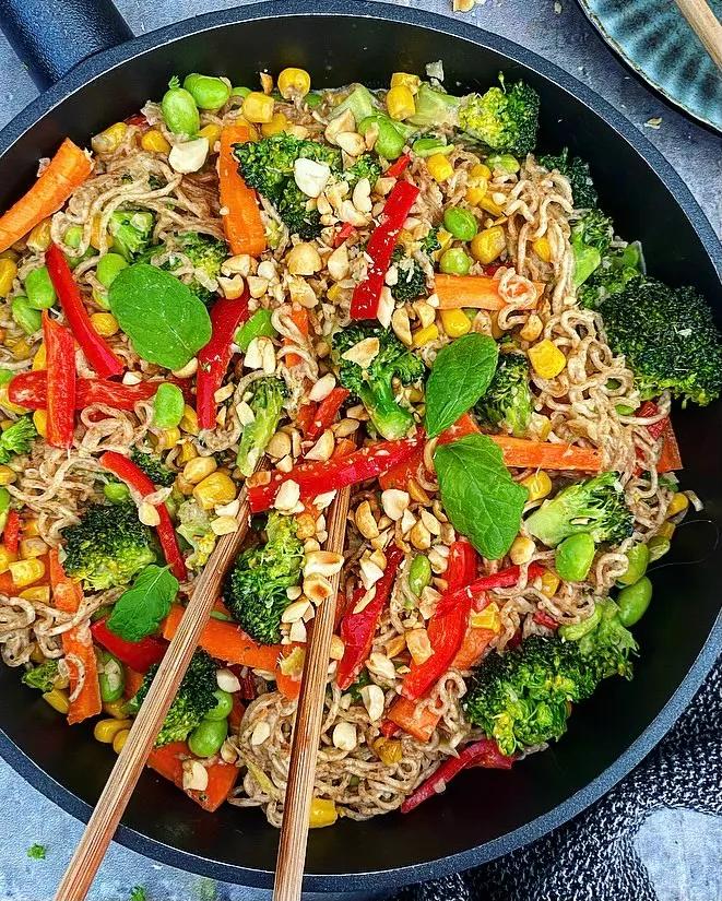 overhead view of a wok with the curried coconut stir-fry being cooked