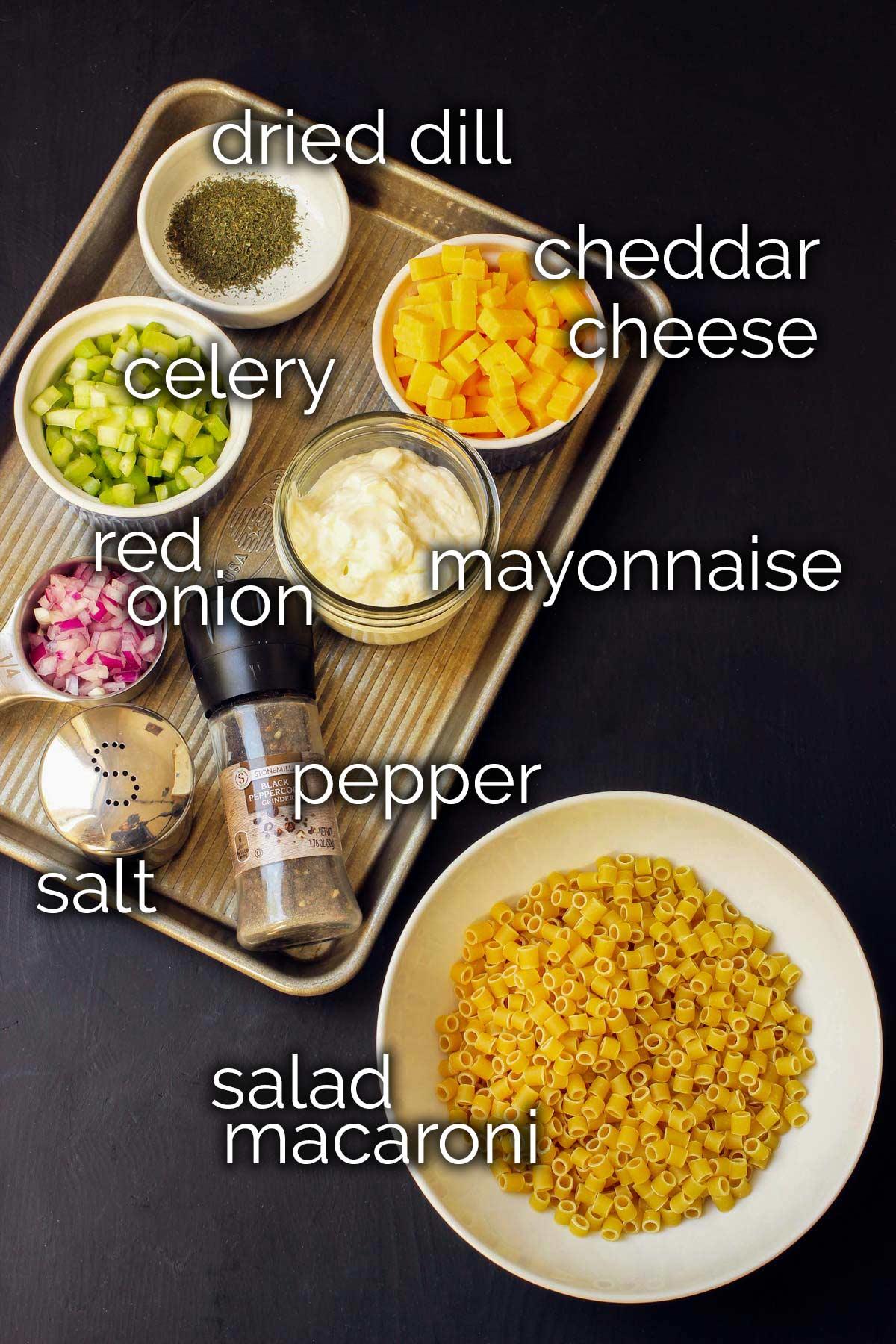 ingredients for summer macaroni salad laid out on a table