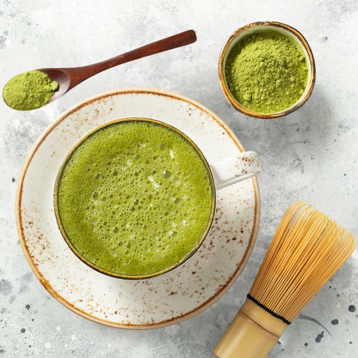matcha powder being whisked into hot water in a bowl
