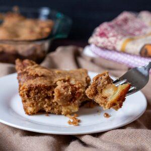 slice of apple crisp coffee cake on a plate, with a fork