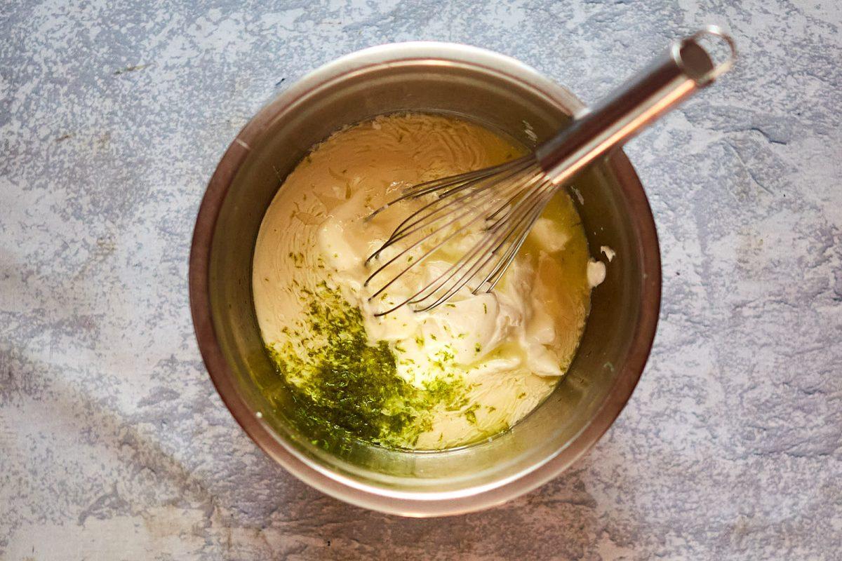 Close-up shot of key lime pie filling being mixed in a bowl