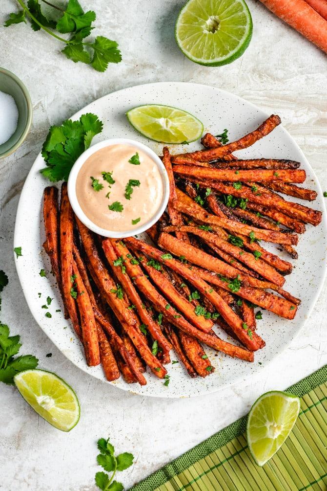 person preparing carrot fries with lemon pepper seasoning