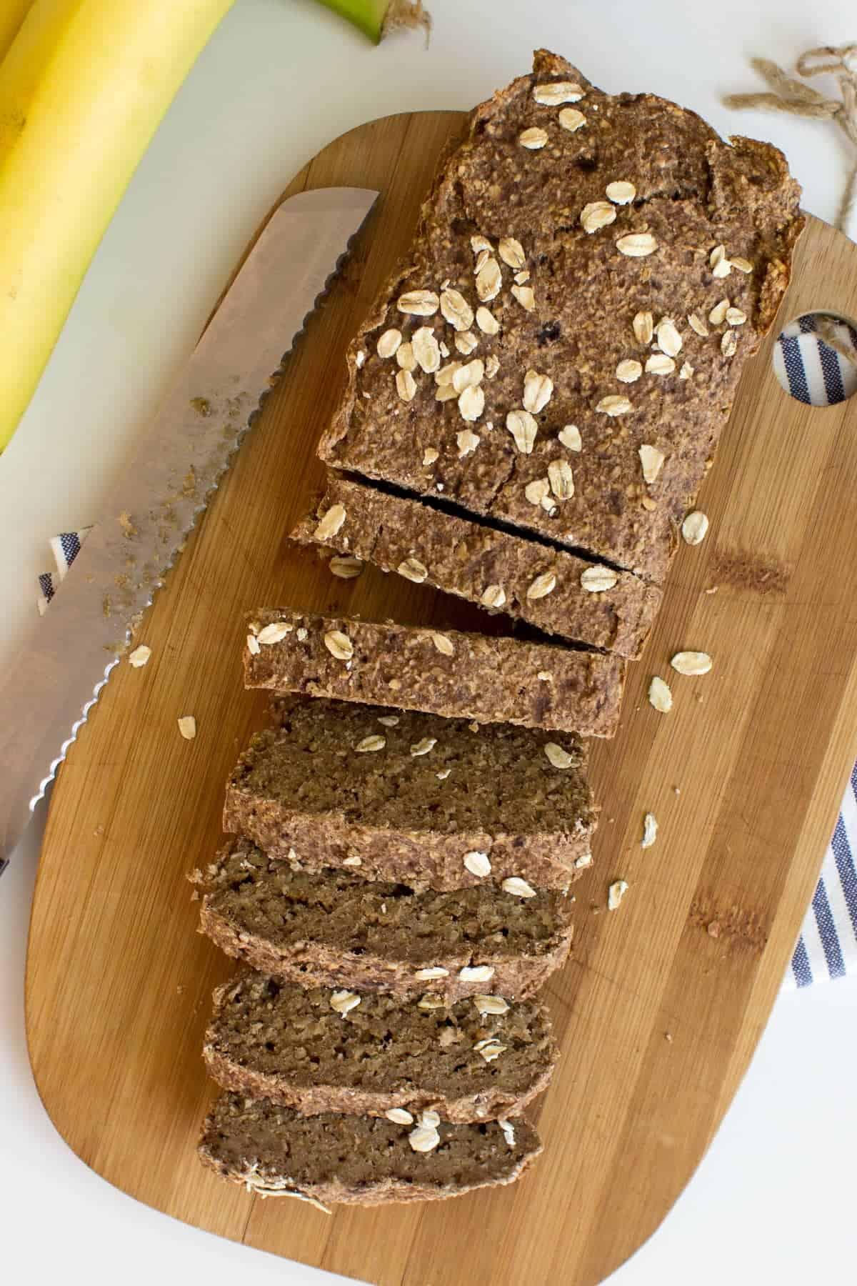 vegan gluten-free banana bread slices on a wooden board