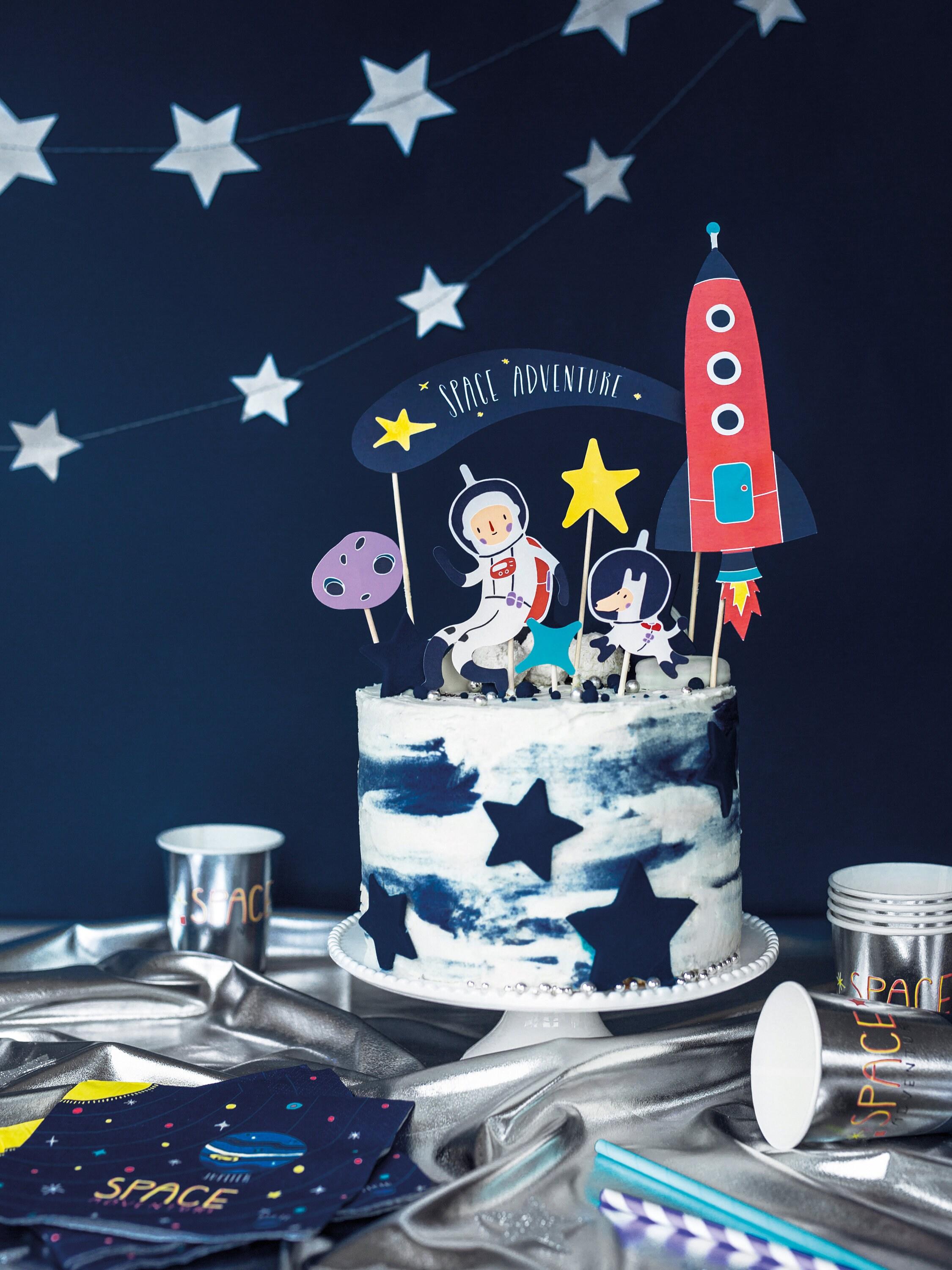 close up of a detailed cake decoration of a rocket and stars