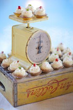 A beautifully decorated cake on a vintage scale, with measuring weights nearby
