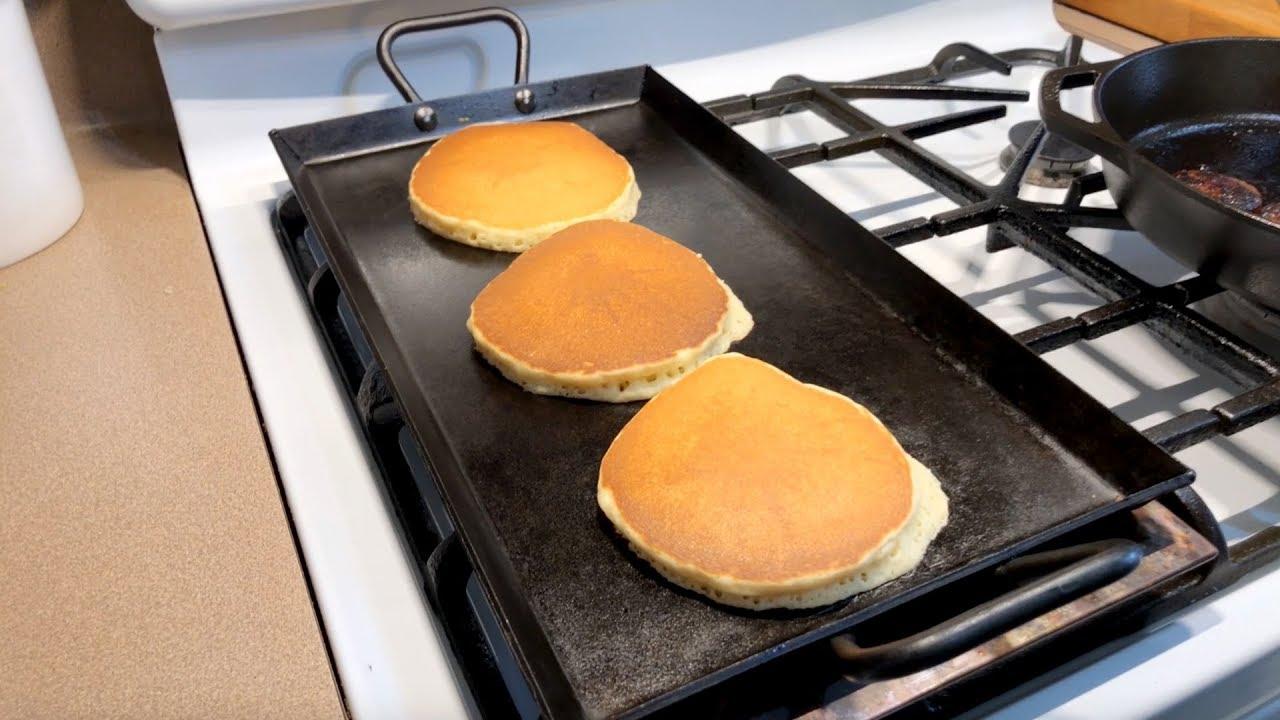 pancakes being cooked on a griddle