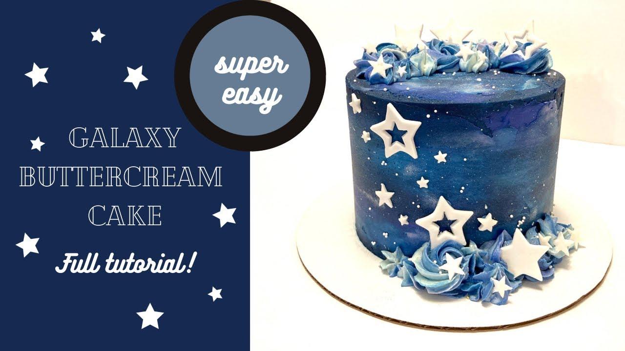 A beautifully decorated multi-layered cake with galaxy-themed decorations