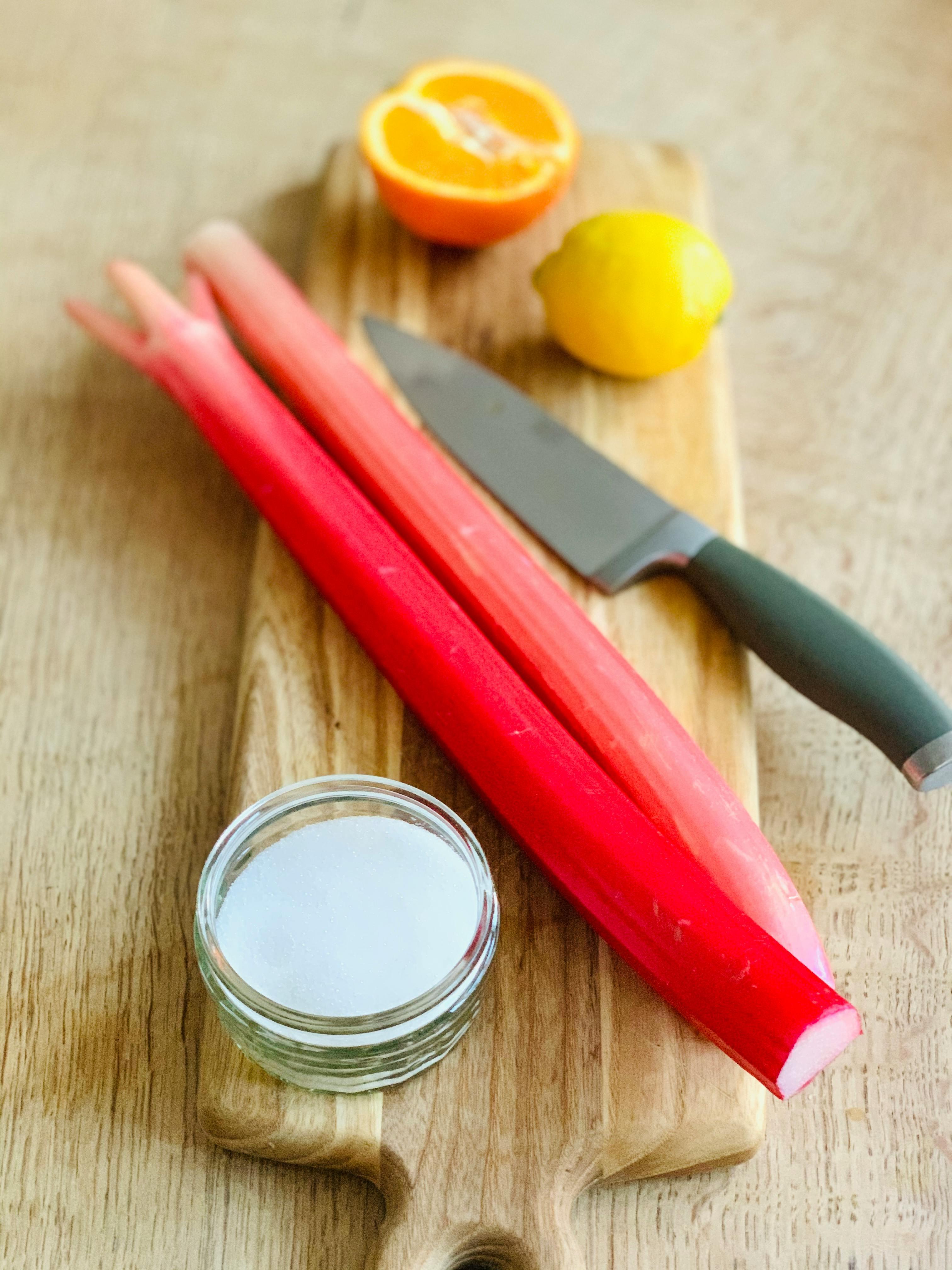 Close up of rhubarb stalks being chopped on a cutting board