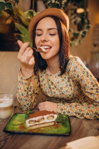 woman happily eating tiramisu pop
