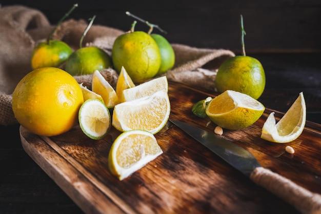 close-up shot of fresh strawberries and lemons on a wooden cutting board