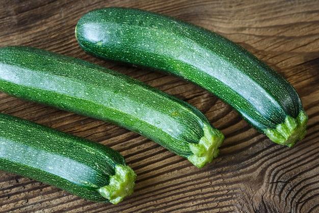 fresh zucchini and walnuts on a rustic wooden table