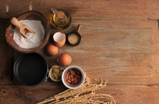 Overhead shot of various baking ingredients laid out on a wooden table, ready for use