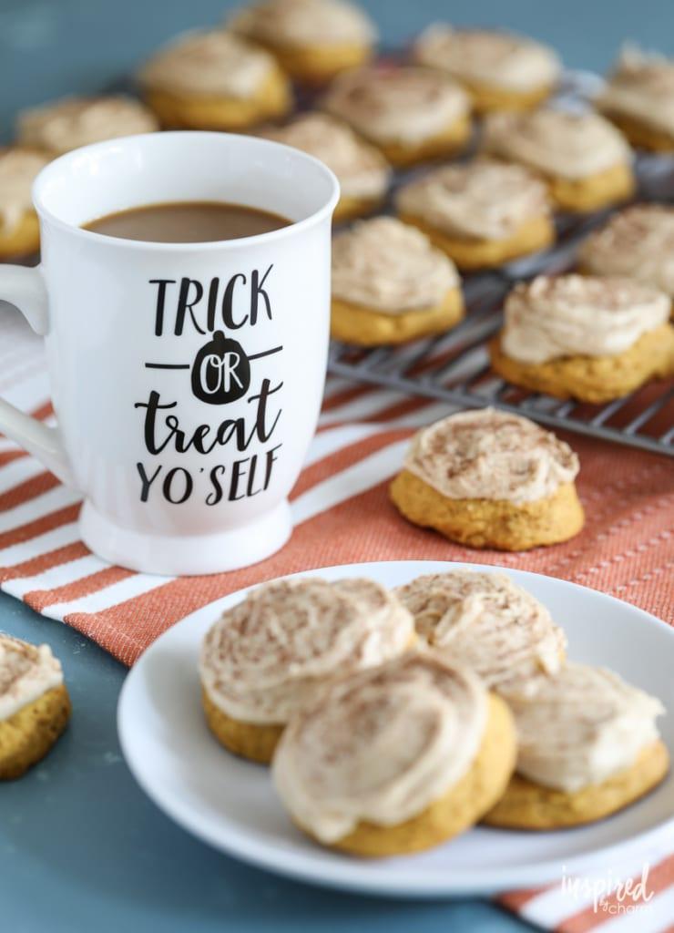 A person dipping a pumpkin spice latte cookie into a cup of coffee