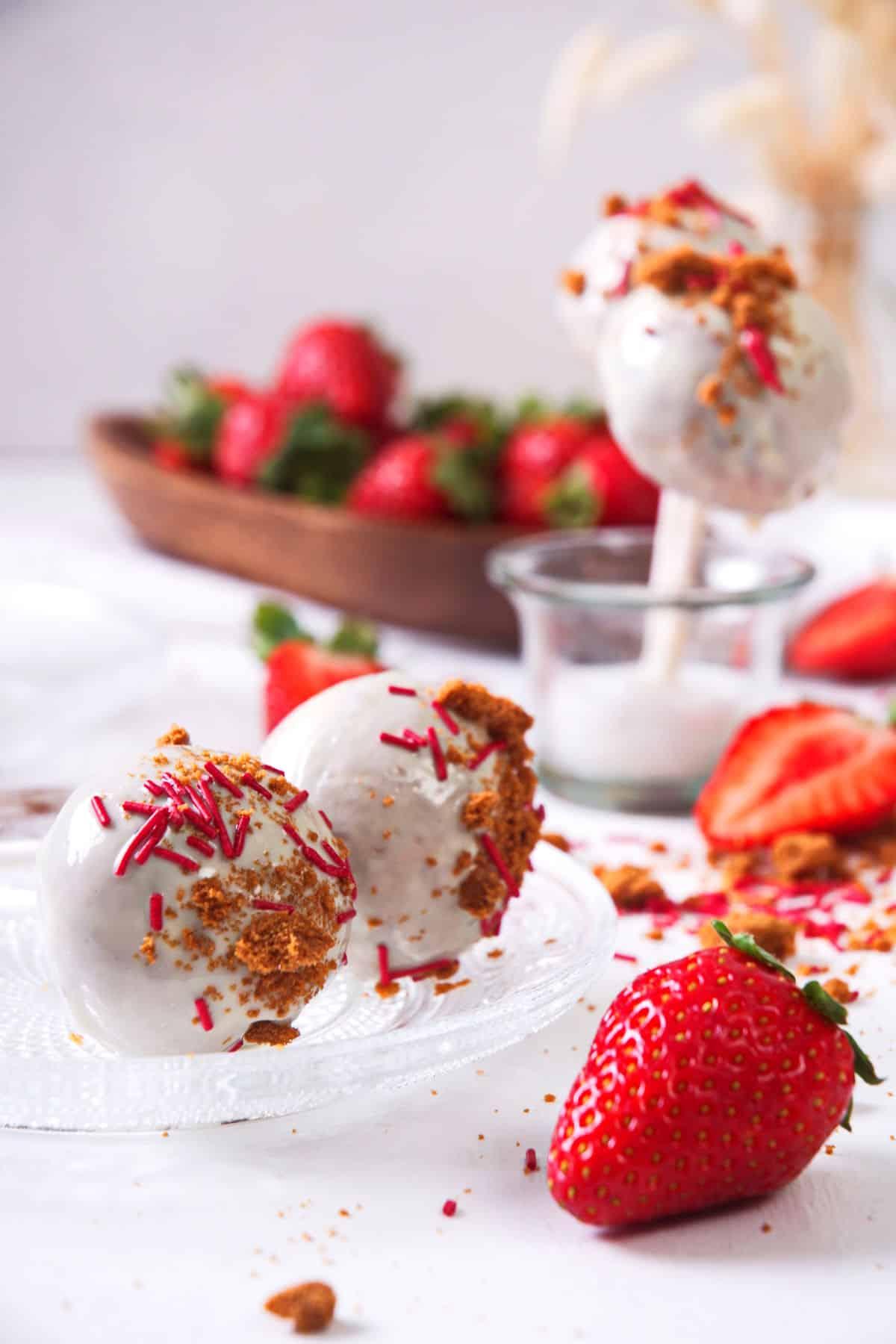 Frozen strawberry shortcake pops with fresh strawberries and whipped cream